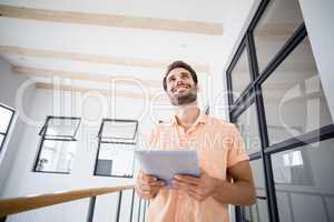 Man holding digital tablet at home