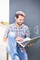 Man sitting on terrace using laptop