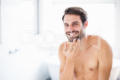 Man checking his stubble in bathroom