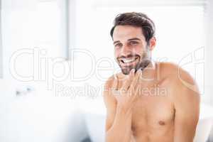 Man checking his stubble in bathroom