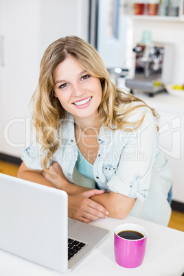 Young woman sitting at worktop