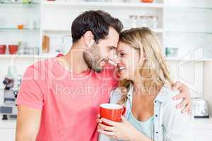 Young couple holding coffee mug