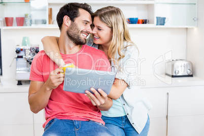 Young couple holding digital tablet Young couple holding digital tablet