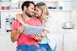 Young couple holding digital tablet