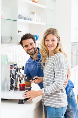 Young couple preparing coffee from coffeemaker