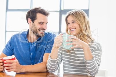 Young couple holding coffee mug