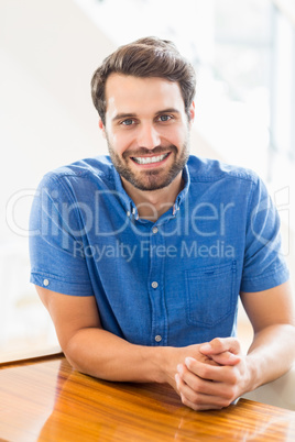 A Man is sitting at table