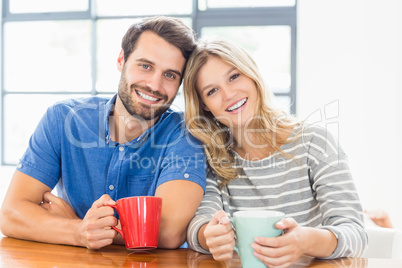 Young couple holding coffee mug