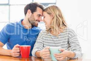 Young couple holding coffee mug