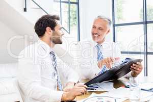 Two businessmen are smiling each other