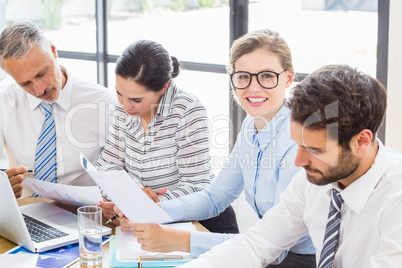 Businesswoman sitting at desk and smiling