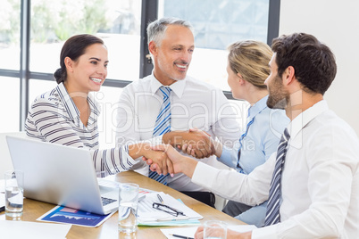 Business colleagues shaking hands during a meeting