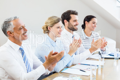 Business colleagues applauding in a meeting