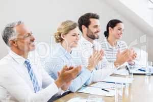 Business colleagues applauding in a meeting