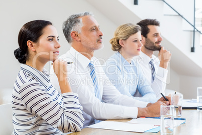 Business colleagues sitting together in meeting