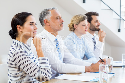 Business colleagues sitting together in meeting Business colleagues sitting together in meeting
