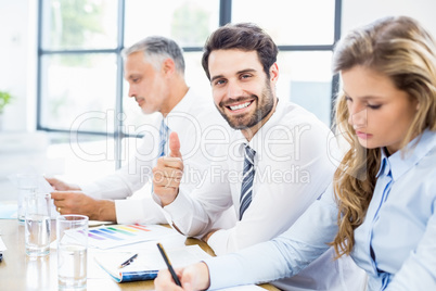 Portrait of businessman showing thumbs up