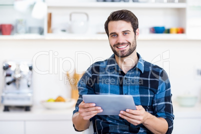 A man is holding some documents and smiling