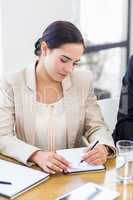 A businesswoman is concentrating and looking at her notes