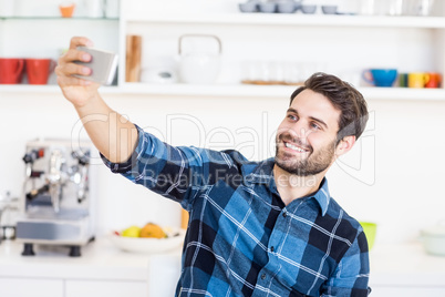 A man is taking a picture of himself with a smartphone