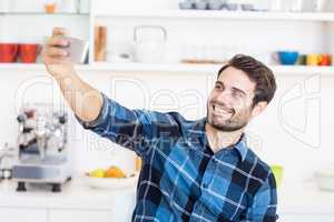 A man is taking a picture of himself with a smartphone