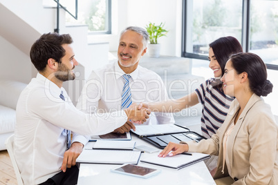 Businessmen shaking hands with businesswomen