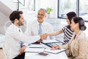 Businessmen shaking hands with businesswomen