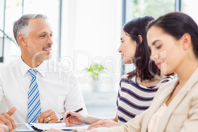 Businesspeople discussing at desk