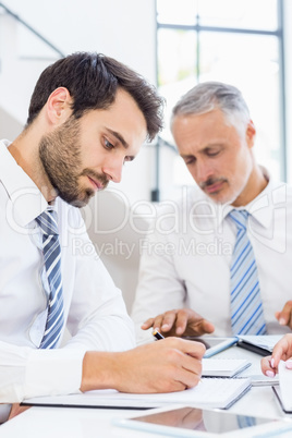 Businessman writing in a diary