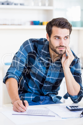 A businessman is posing and holding a pen in his hand