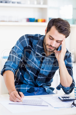 A man is concentrating on his notes