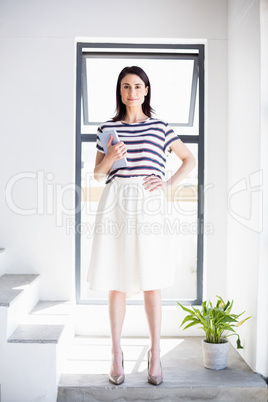 Young woman holding digital tablet