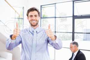 Businessman showing his thumbs up