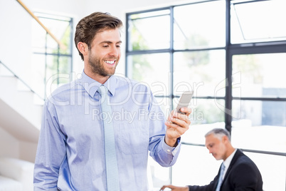 Businessman texting a message on phone