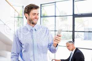 Businessman texting a message on phone