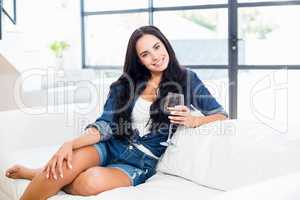 Portrait of woman sitting with a glass of red wine