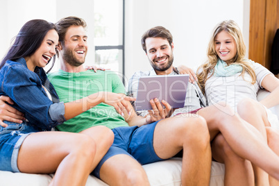 Friends are smiling and looking at a touchscreen