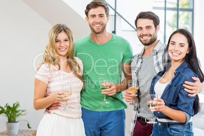 Two cute couple smiling with alcohol glass in hand