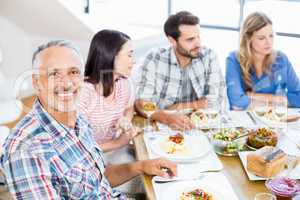 Man sitting with friends at dinning table