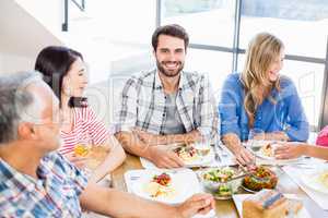 Man sitting with friends at dinning table