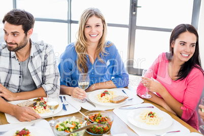 Woman sitting with friends at dinning table