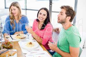 Woman sitting with friends at dinning table