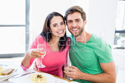 Young couple holding a wine glass