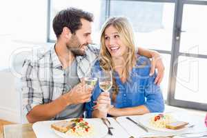 Young couple toasting wine glasses