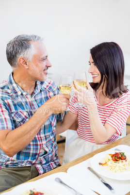 Young couple toasting wine glasses