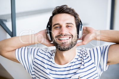 Man relaxing and listening to music on headphone