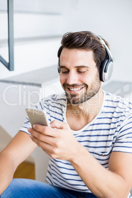 Happy man listening to music on mobile phone