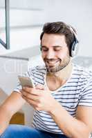 Happy man listening to music on mobile phone