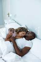 Young couple sleeping together on bed