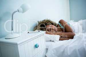 Young woman sleeping on bed